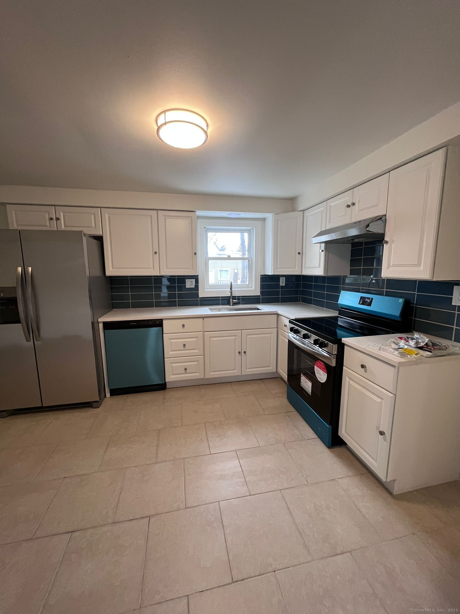 46 Orchard Street, Unit 52C New Haven, CT 06519 - Photo 7 of 12 a large kitchen with granite countertop a stove a sink dishwasher and a refrigerator