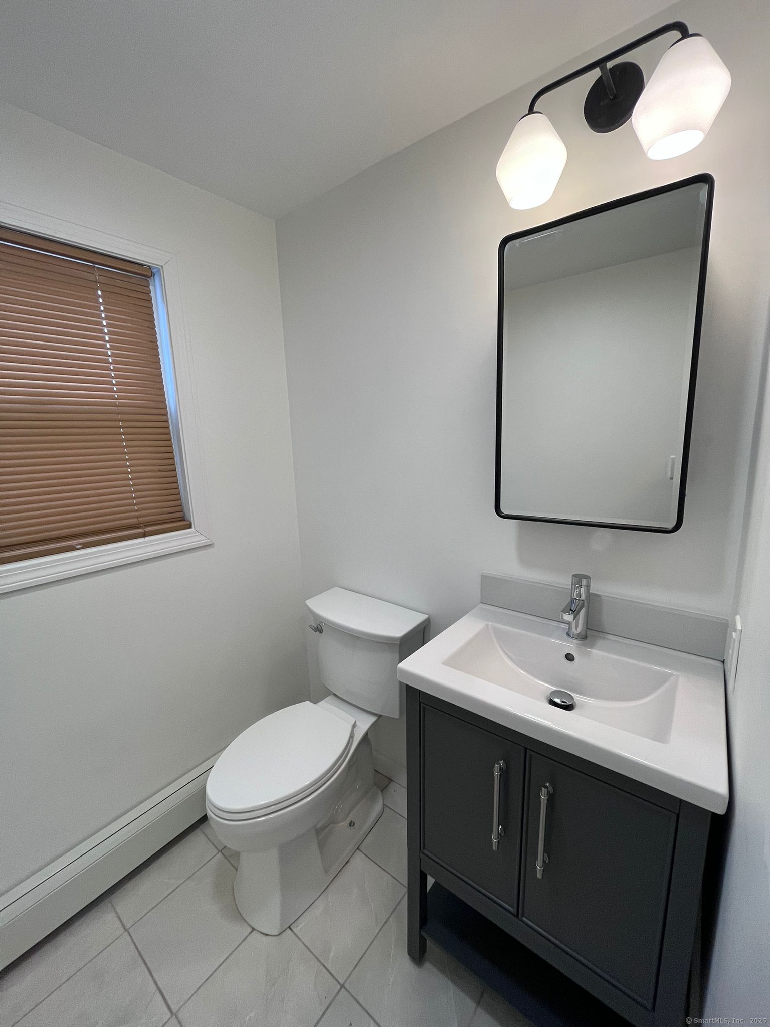 46 Orchard Street, Unit 52C New Haven, CT 06519 - Photo 8 of 12 a bathroom with a toilet sink and mirror