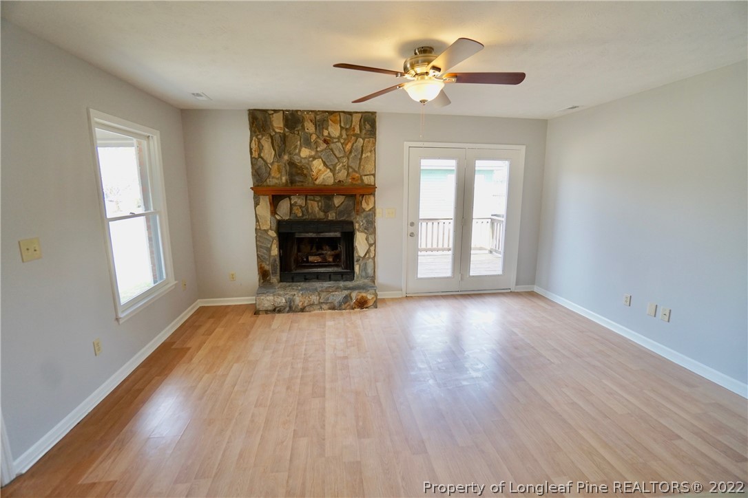 2537 Previs Road Fayetteville, NC 28306 - Photo 13 of 37 wooden floor fireplace and windows in an empty room