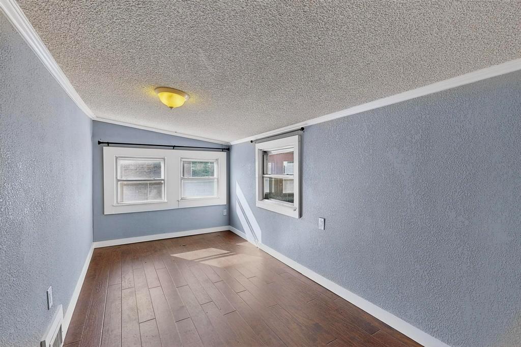 507 North Rusk Street Weatherford, TX 76086 - Photo 18 of 35 wooden floor in an empty room with a window