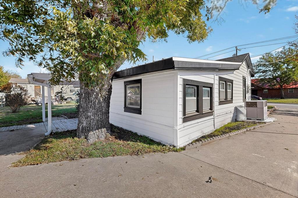 507 North Rusk Street Weatherford, TX 76086 - Photo 25 of 35 a white house that has a tree in front of it