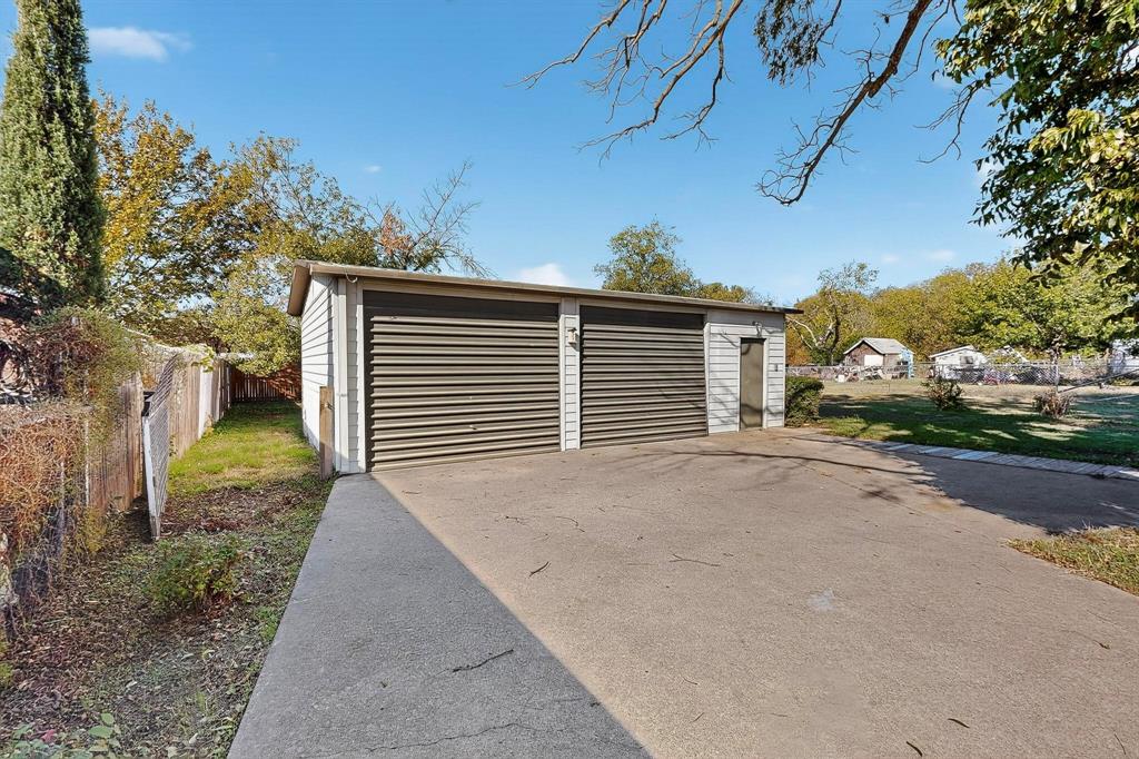 507 North Rusk Street Weatherford, TX 76086 - Photo 31 of 35 a view of a house with a backyard and road