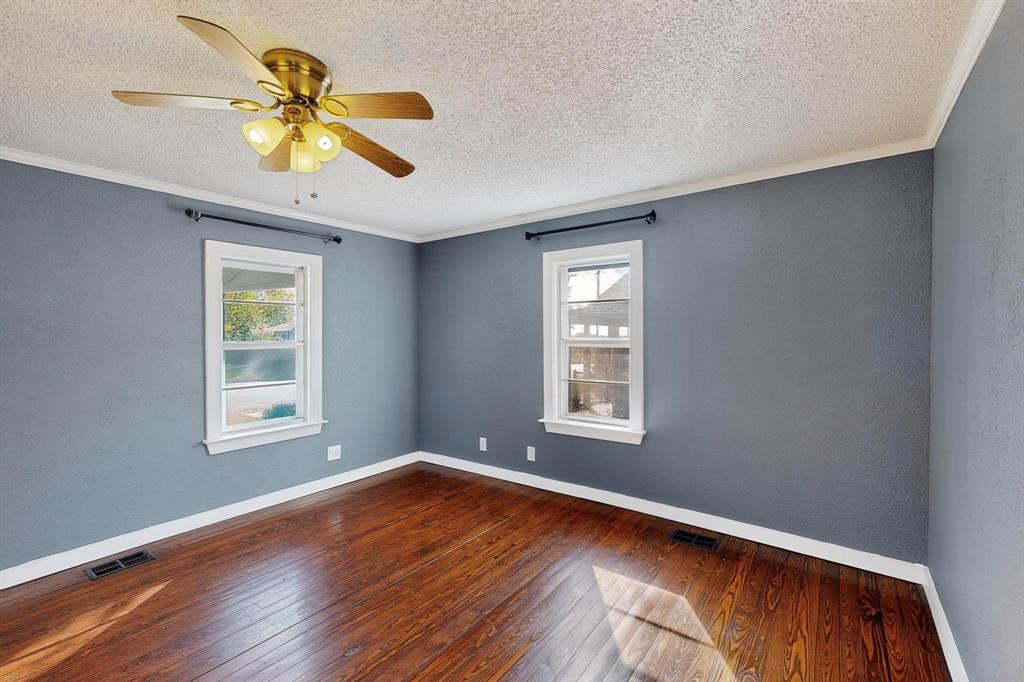507 North Rusk Street Weatherford, TX 76086 - Photo 7 of 35 wooden floor in an empty room with a window