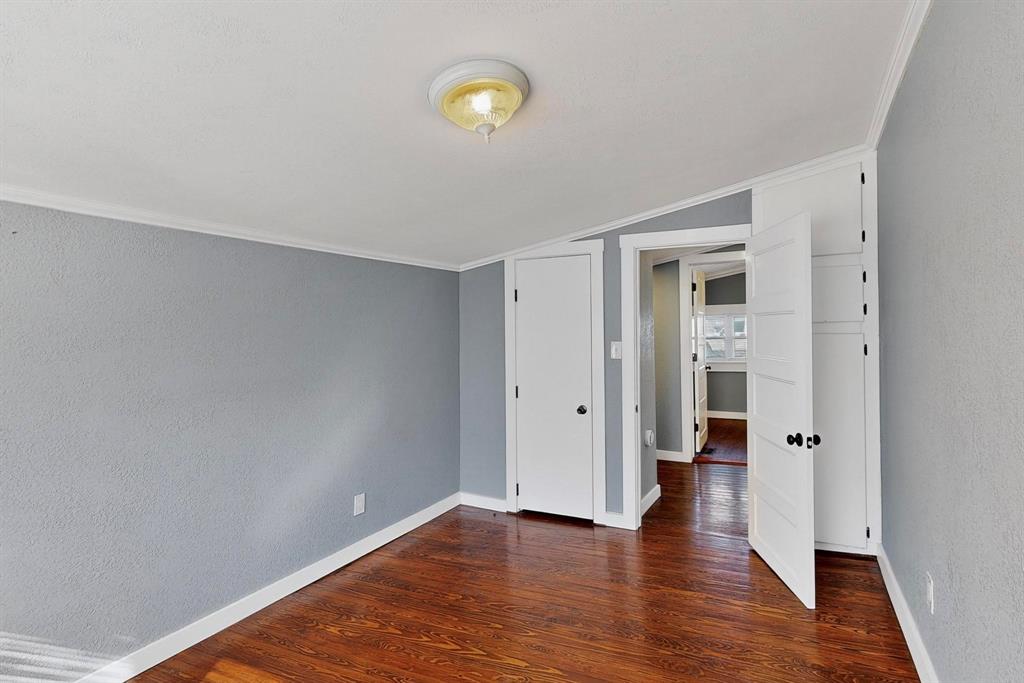 507 North Rusk Street Weatherford, TX 76086 - Photo 9 of 35 a view of an empty room with wooden floor