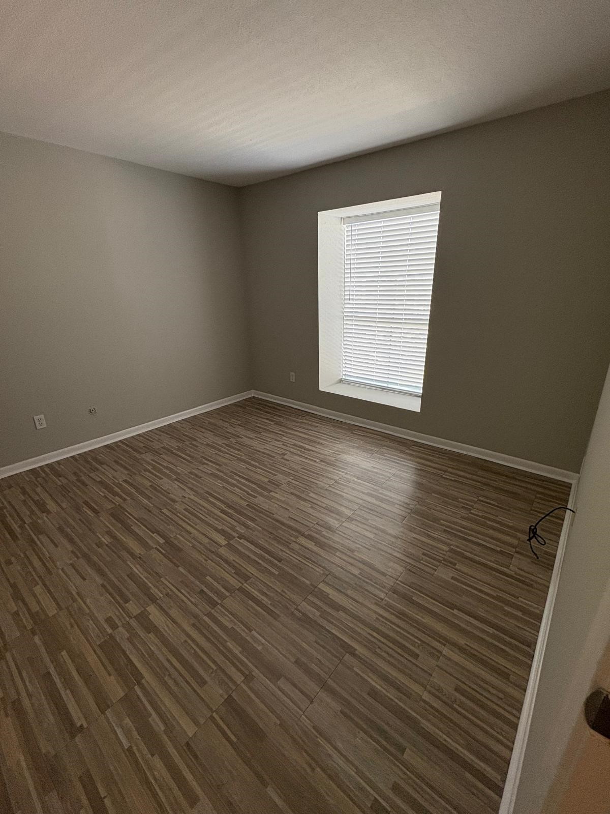3055 Walnut Bend Lane, Unit 33 Houston, TX 77042 - Photo 4 of 18 an empty room with wooden floor and windows