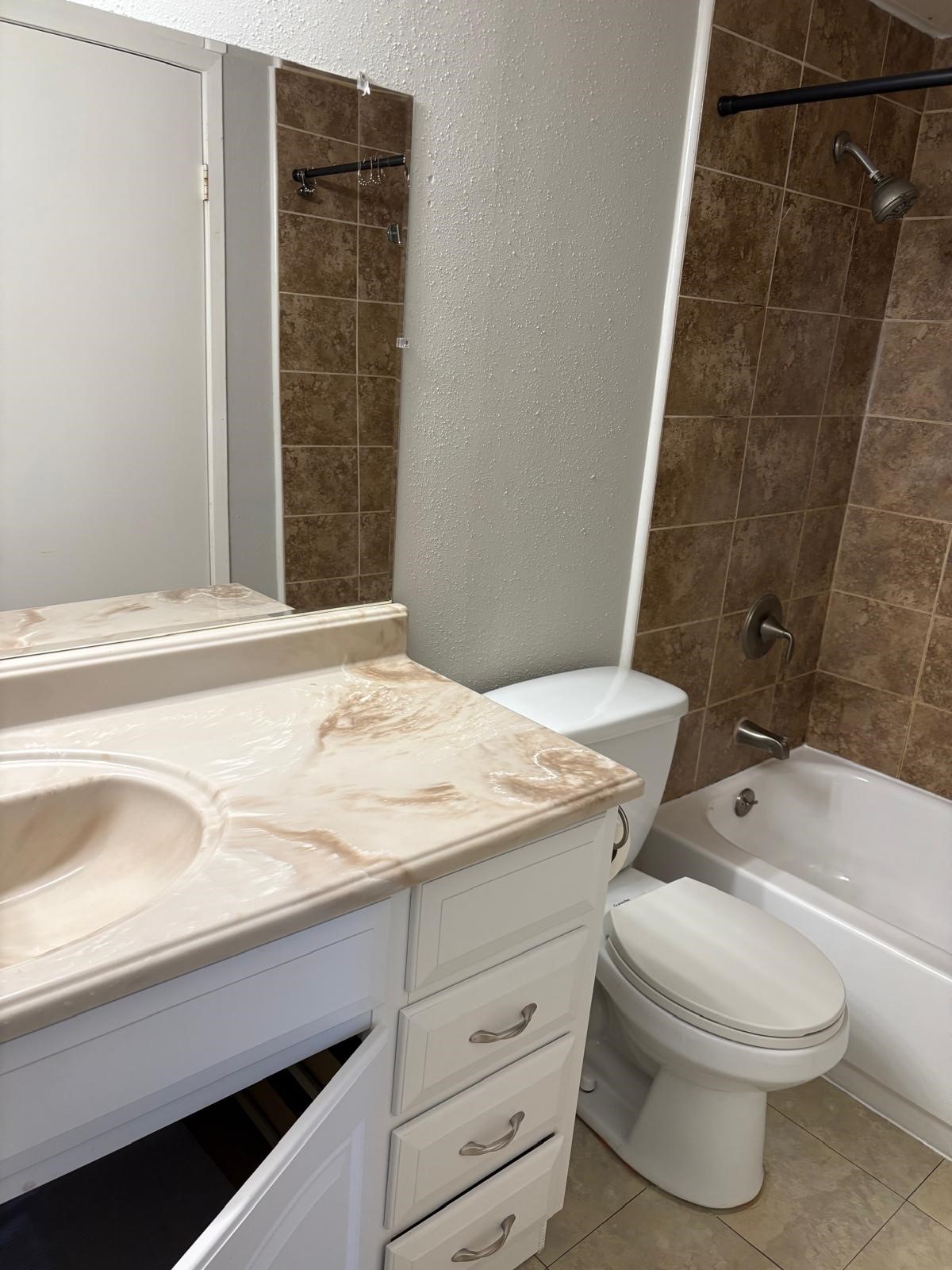 3055 Walnut Bend Lane, Unit 33 Houston, TX 77042 - Photo 7 of 18 a bathroom with a granite countertop toilet a sink and bathtub