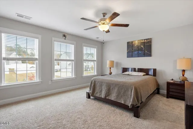 a spacious bedroom with a bed and a large window