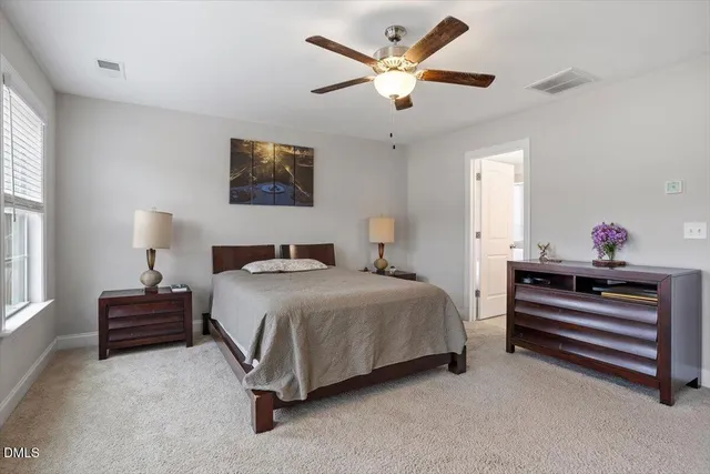 a bedroom with bed and a chandelier