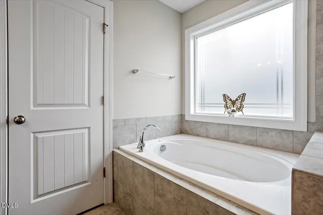 a white bath tub sitting next to a window