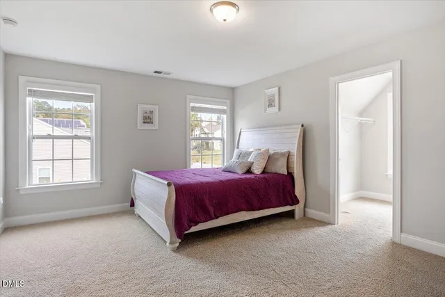 a spacious bedroom with a bed and a window