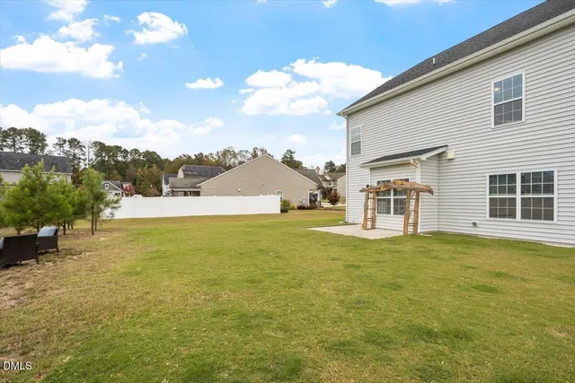 a view of an house with pool and a yard