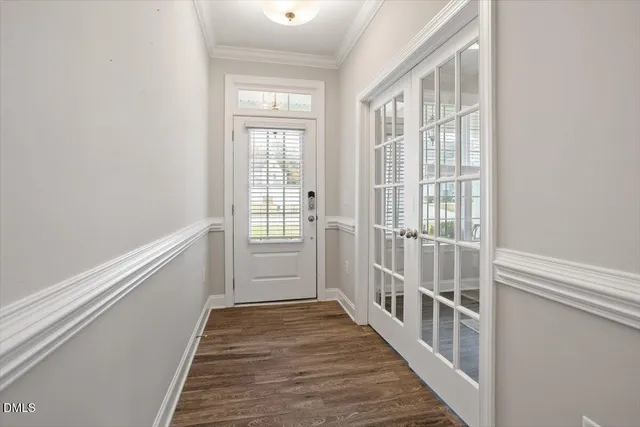 a view of a hallway with wooden floor and windows