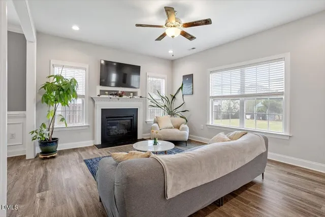 a living room with furniture a fireplace and a flat screen tv