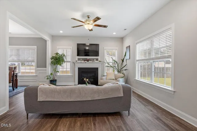 a living room with furniture a fireplace and a flat screen tv
