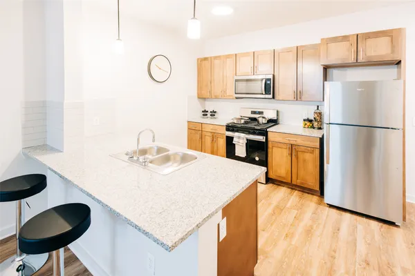 a kitchen with a refrigerator a stove a sink and a cabinets