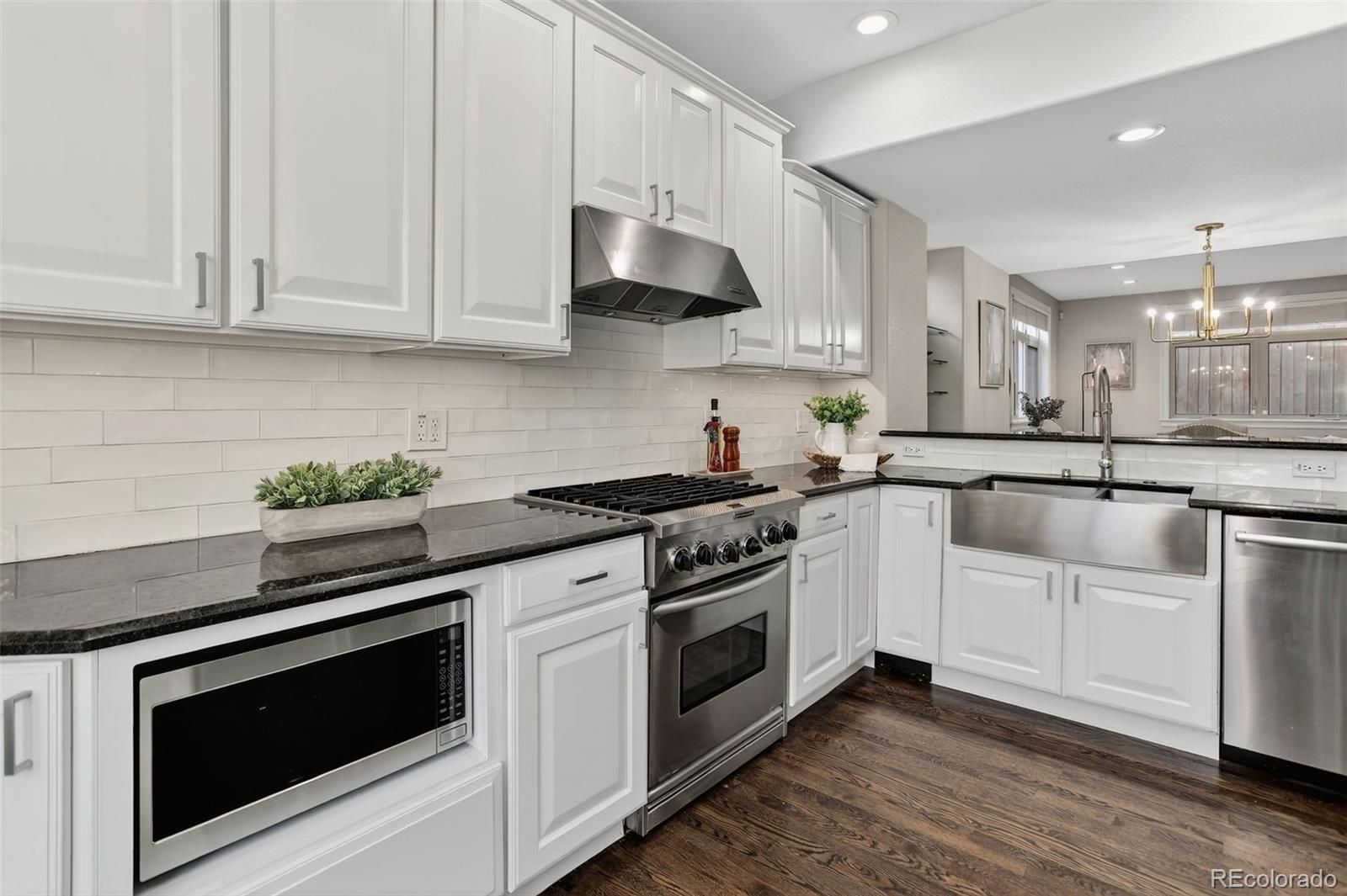 2311 Decatur Street Denver, CO 80211 - Photo 11 of 31 a white kitchen with granite countertop stainless steel appliances