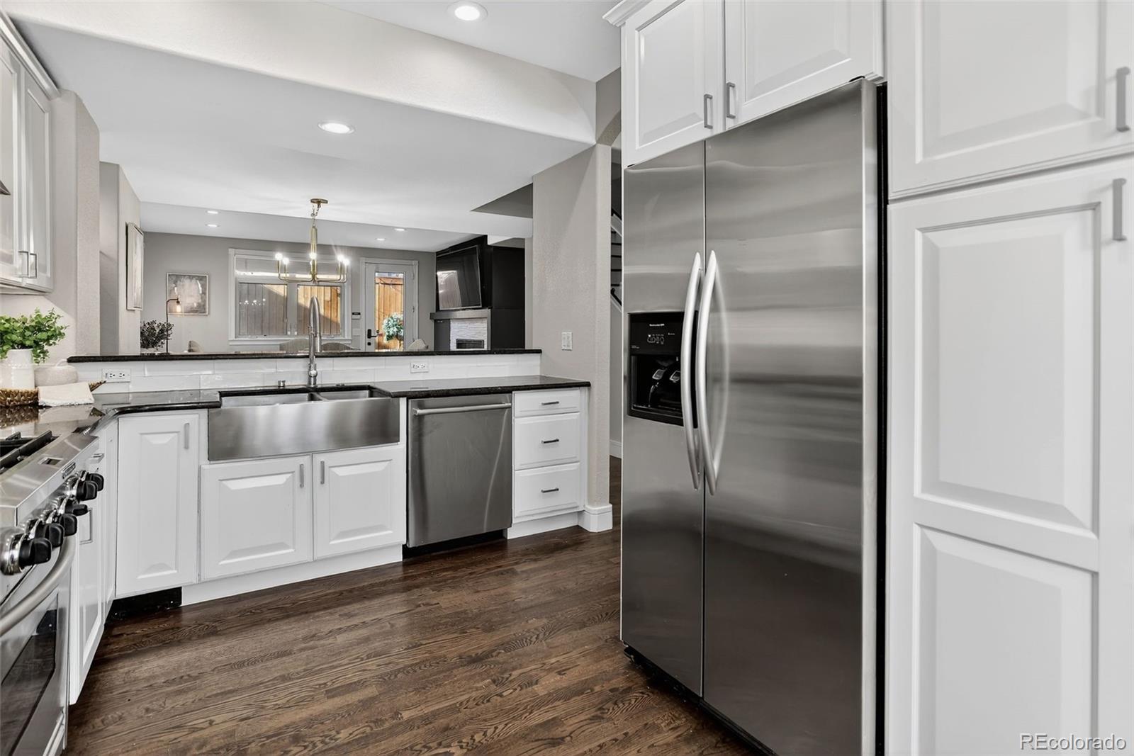 2311 Decatur Street Denver, CO 80211 - Photo 12 of 31 a kitchen with cabinets stainless steel appliances and a counter space