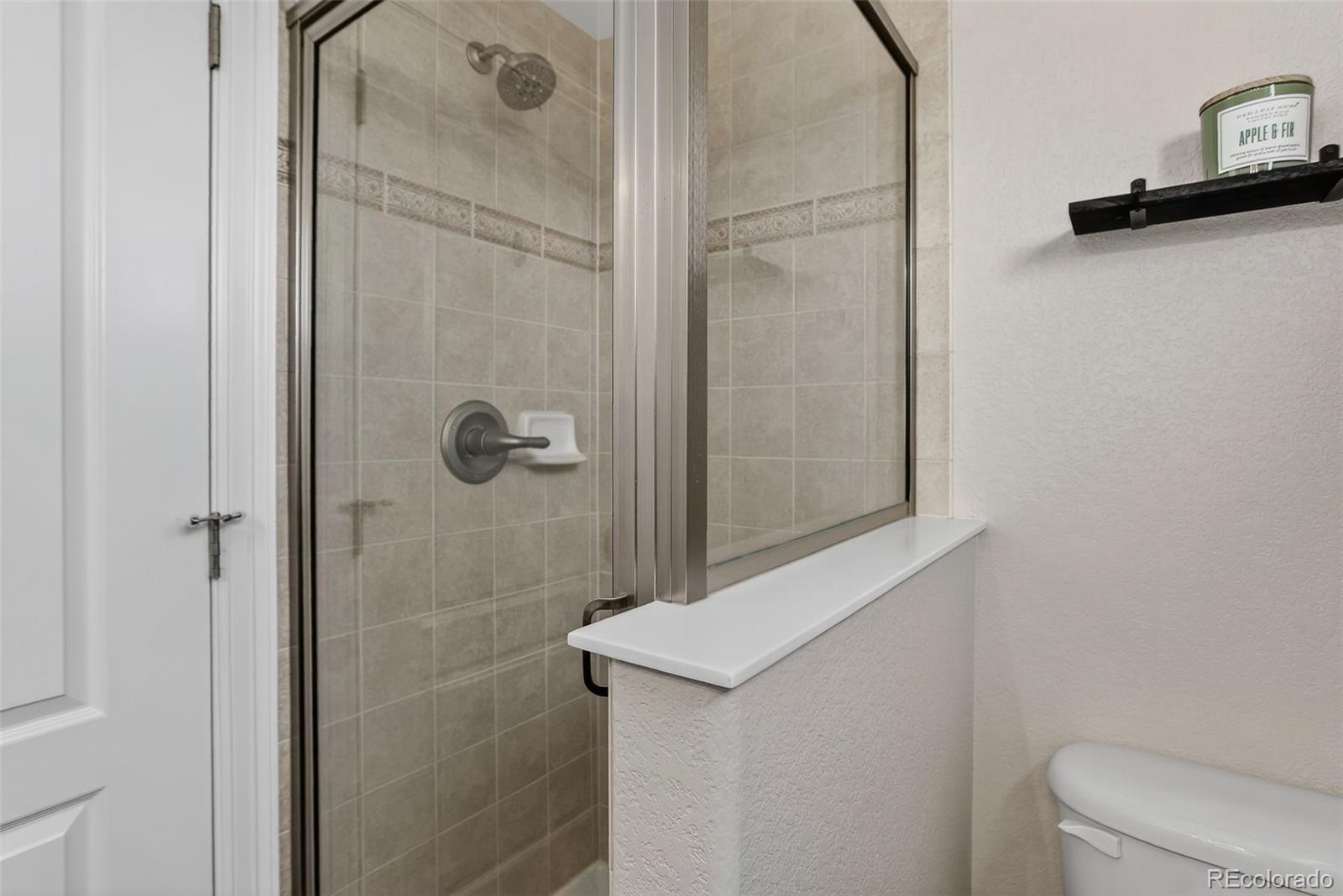2311 Decatur Street Denver, CO 80211 - Photo 20 of 31 a bathroom with a shower toilet and sink