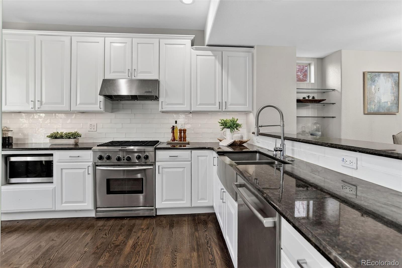 2311 Decatur Street Denver, CO 80211 - Photo 9 of 31 a kitchen with cabinets a sink and stainless steel appliances