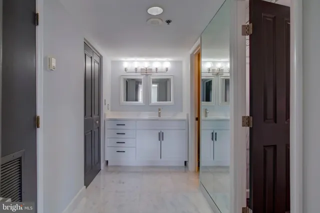 a bathroom with a double vanity sink and mirror