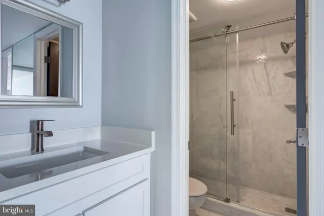 a bathroom with a shower and a sink