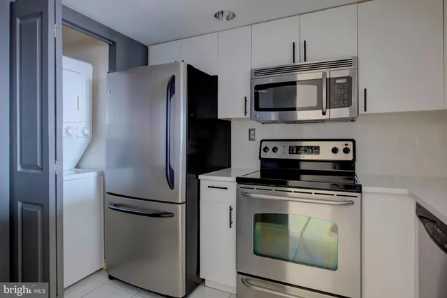 a kitchen with stainless steel appliances a refrigerator stove and microwave