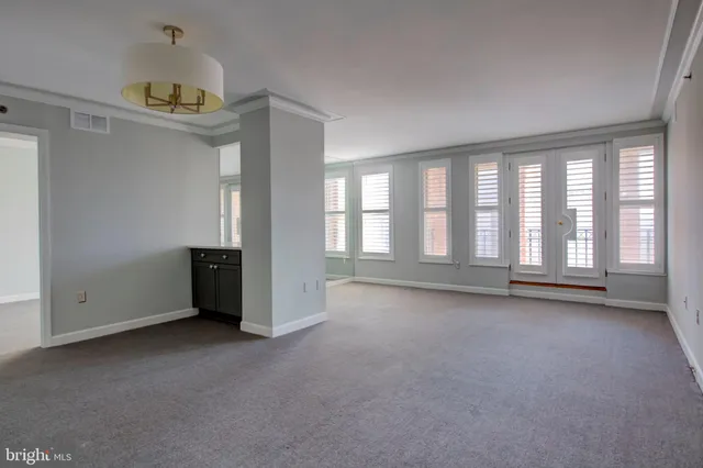 an empty room with projector and windows