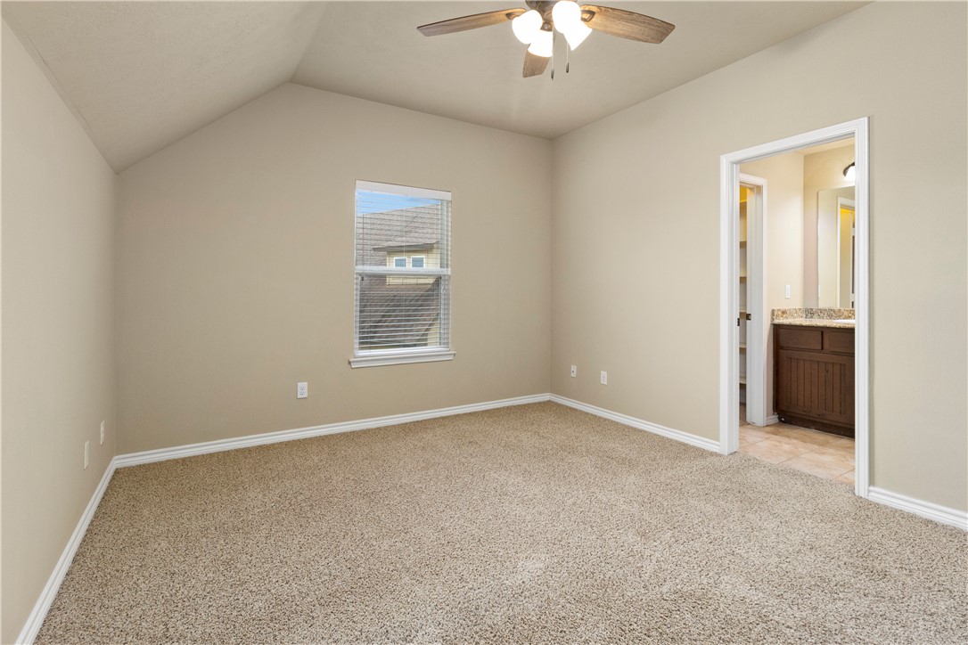 3407 Cullen Trail College Station, TX 77845 - Photo 15 of 22 an empty room with a chandelier fan and windows