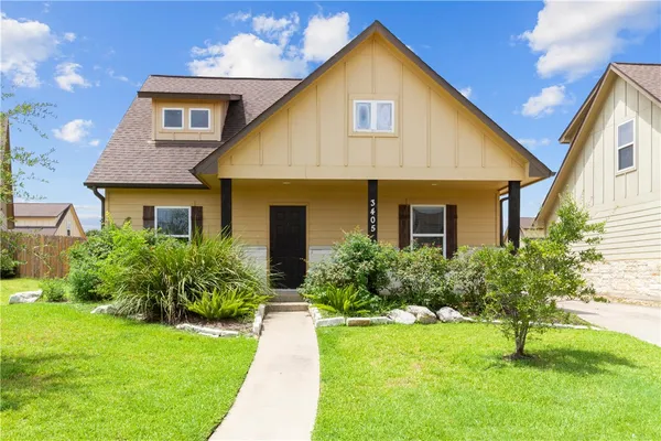 a front view of house with yard and green space