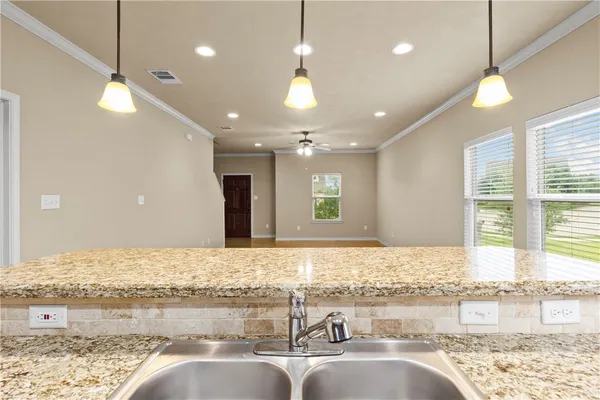 a bathroom with a granite countertop sink and a large mirror