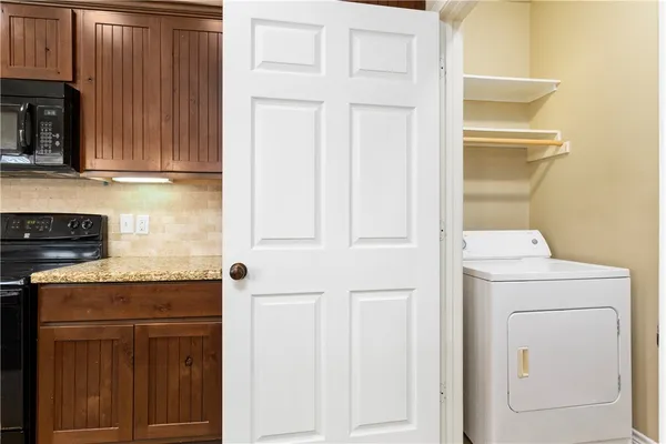 a kitchen with a refrigerator and cabinets