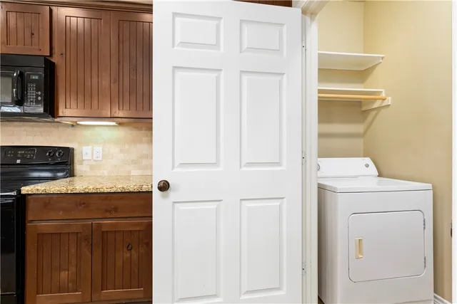 a kitchen with a refrigerator and cabinets