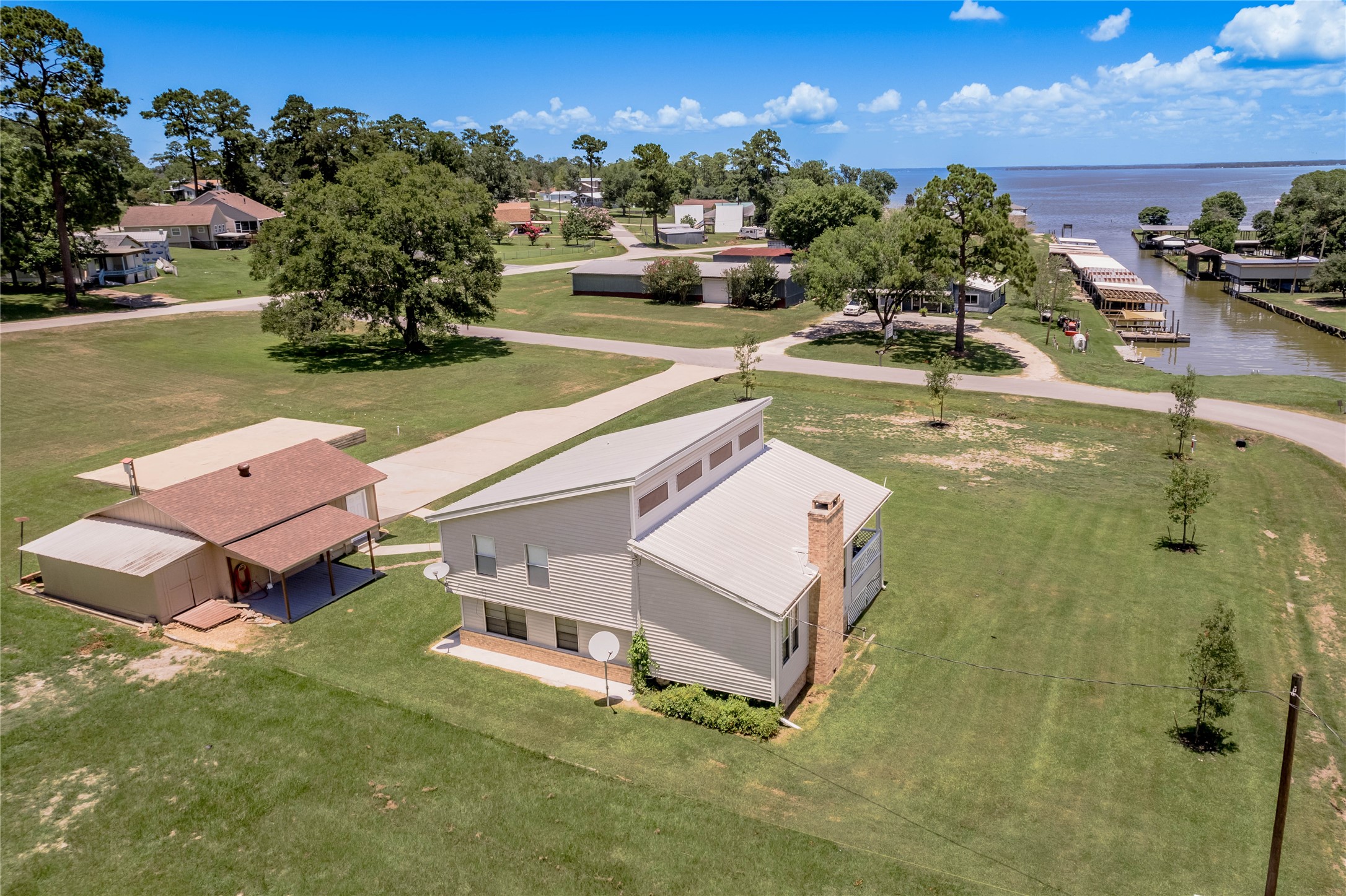 50 Sportsman Trail Coldspring, TX 77331 - Photo 3 of 18 an aerial view of a house with swimming pool and ocean view