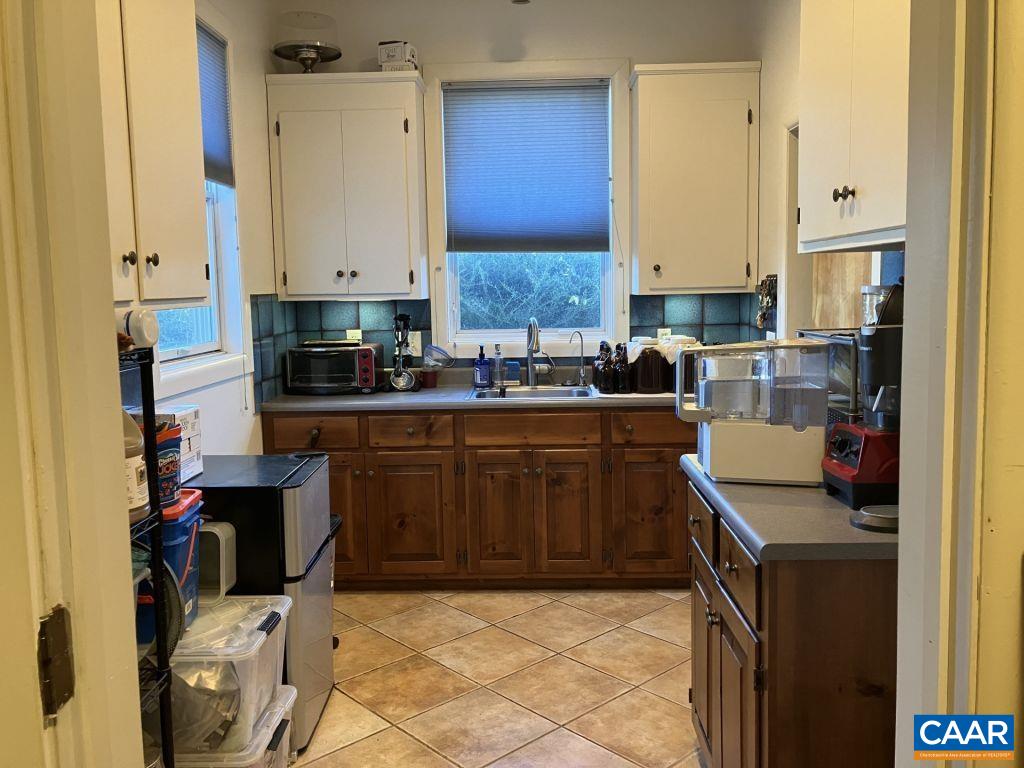 877 Holland Creek Road Louisa, VA 23093 - Photo 13 of 48 a kitchen with a sink stove and cabinets