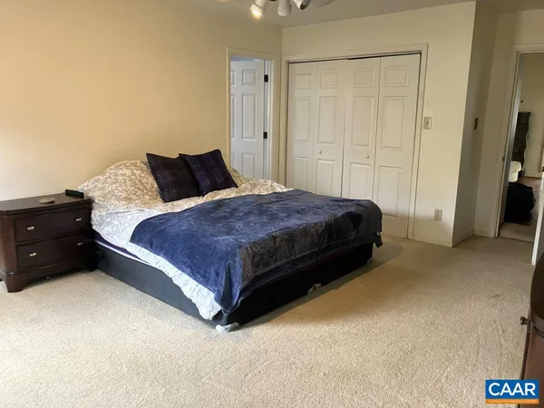 a bedroom with a bed dresser and a window