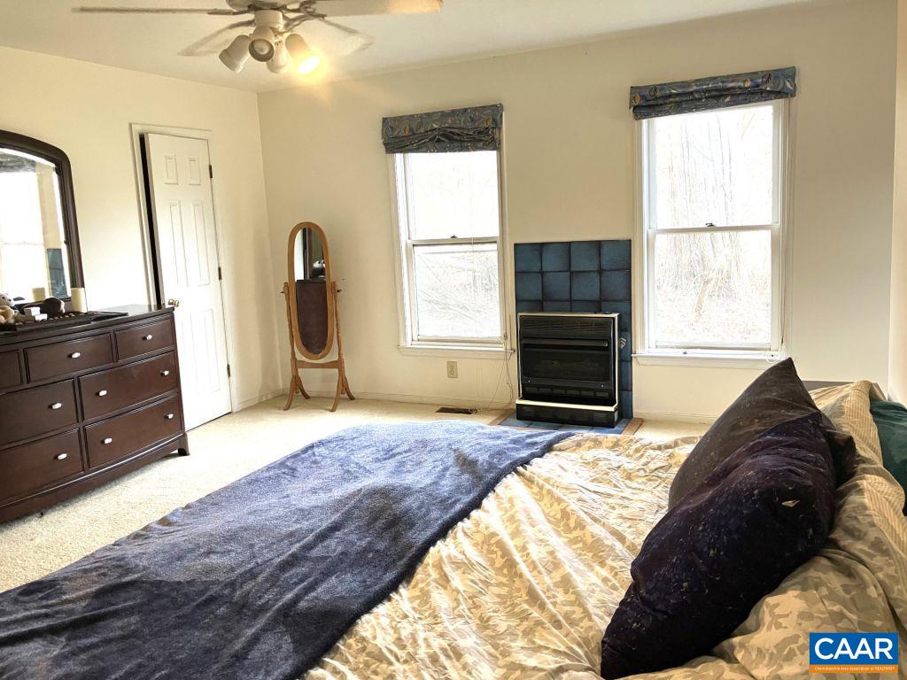 877 Holland Creek Road Louisa, VA 23093 - Photo 18 of 48 a bedroom with a bed dresser and a window