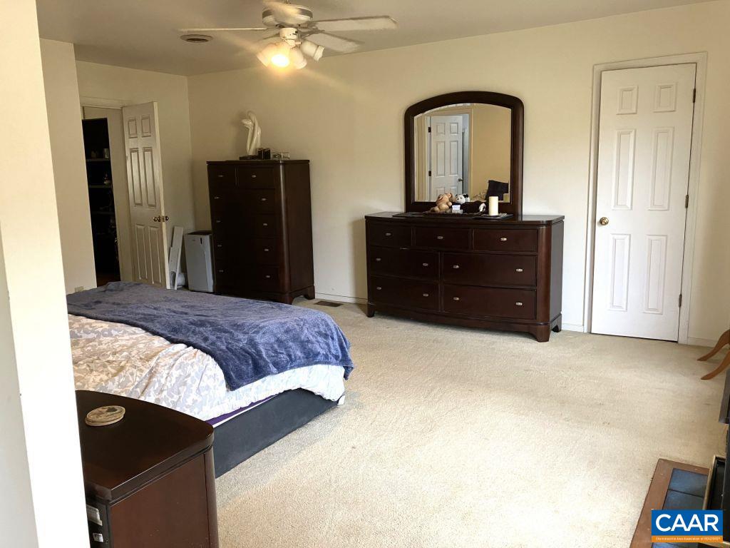 877 Holland Creek Road Louisa, VA 23093 - Photo 19 of 48 a bedroom with a bed and a dresser