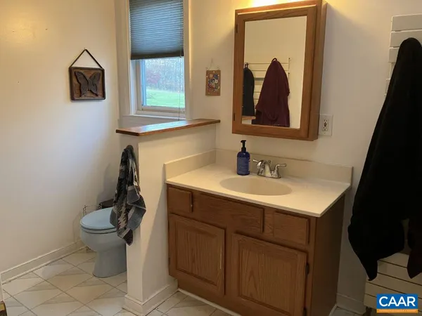 a bathroom with a toilet sink and mirror