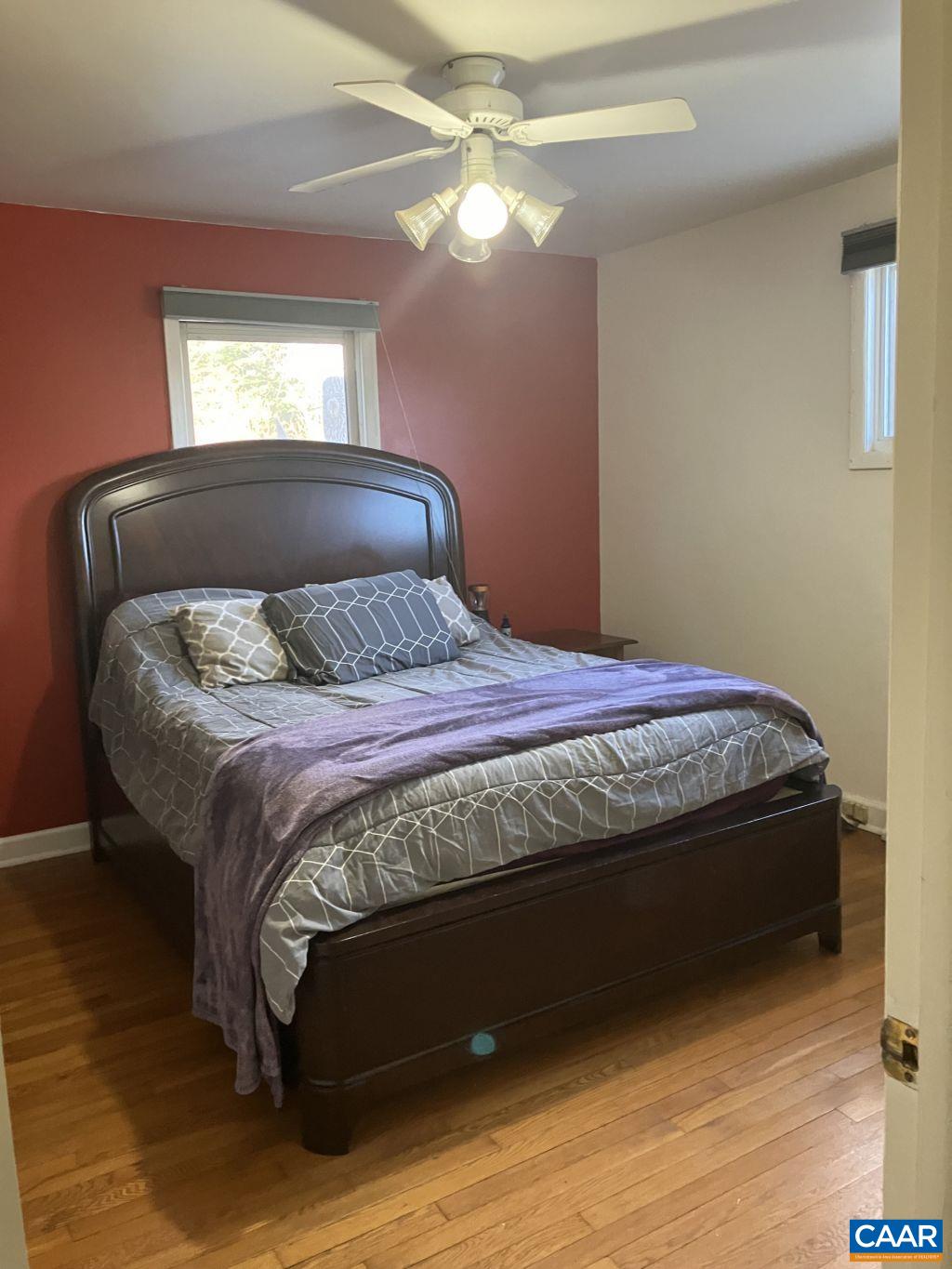 877 Holland Creek Road Louisa, VA 23093 - Photo 23 of 48 a bedroom with a bed and a chandelier