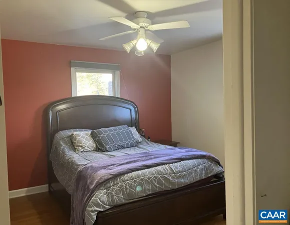 a bedroom with a bed and a large mirror