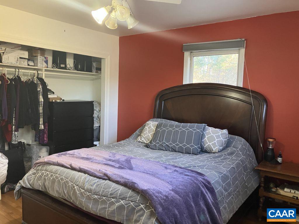 877 Holland Creek Road Louisa, VA 23093 - Photo 25 of 48 a bedroom with a bed and a large mirror