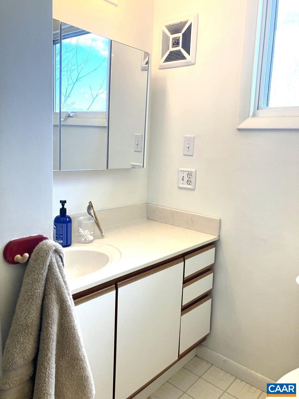 877 Holland Creek Road Louisa, VA 23093 - Photo 26 of 48 a bathroom with a sink and a mirror