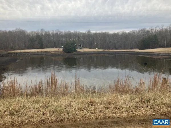 a view of river covered by trees and buildings