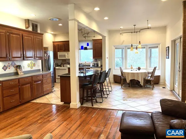 a living room with lots of furniture and kitchen view