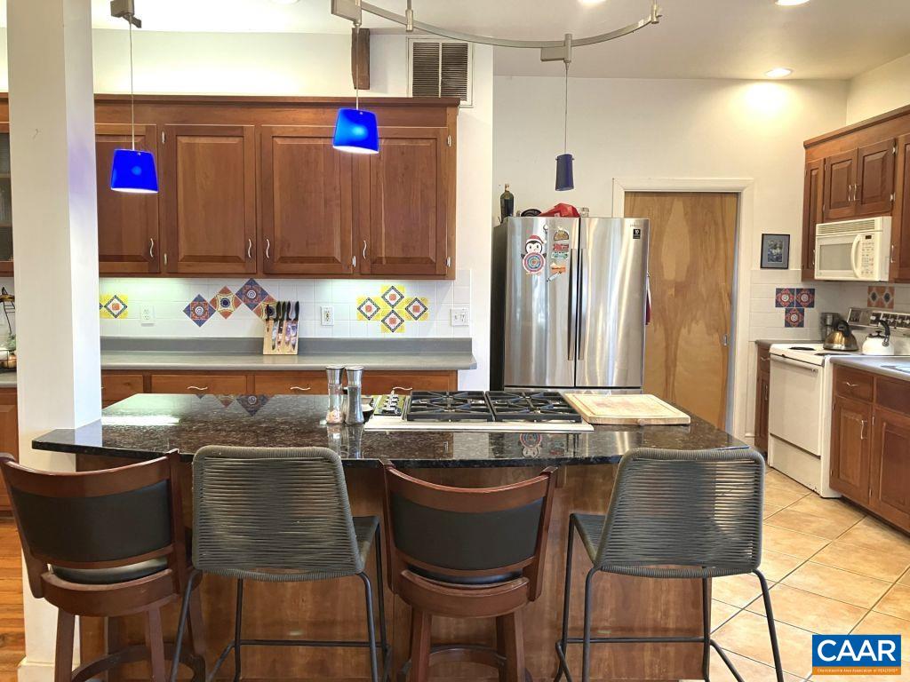 877 Holland Creek Road Louisa, VA 23093 - Photo 9 of 48 a kitchen with a table and chairs in it