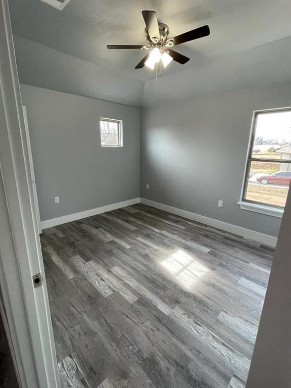 401 West Elm Street Denison, TX 75020 - Photo 12 of 13 a view of empty room with window and ceiling fan