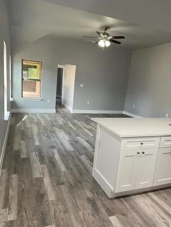 a view of a livingroom with an empty kitchen