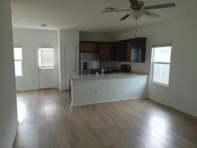 a kitchen with a refrigerator and a sink
