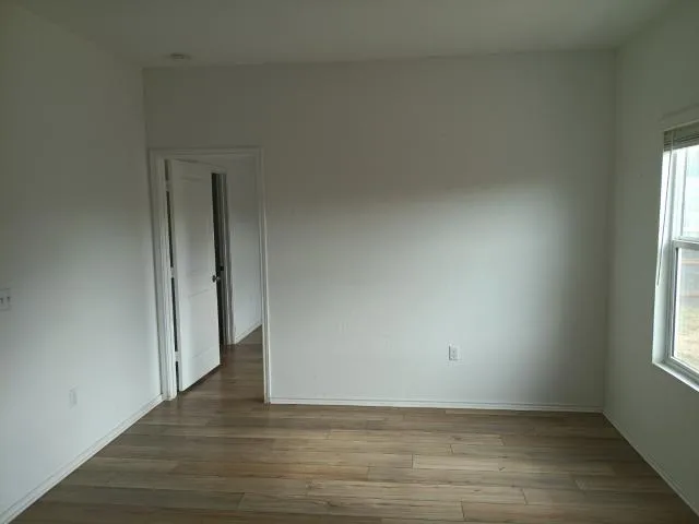 a view of a room with wooden floor