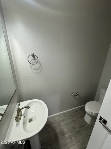 a bathroom with a sink toilet and mirror